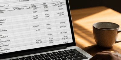 financial planning spreadsheet on laptop screen showing tsp 20260331 100823